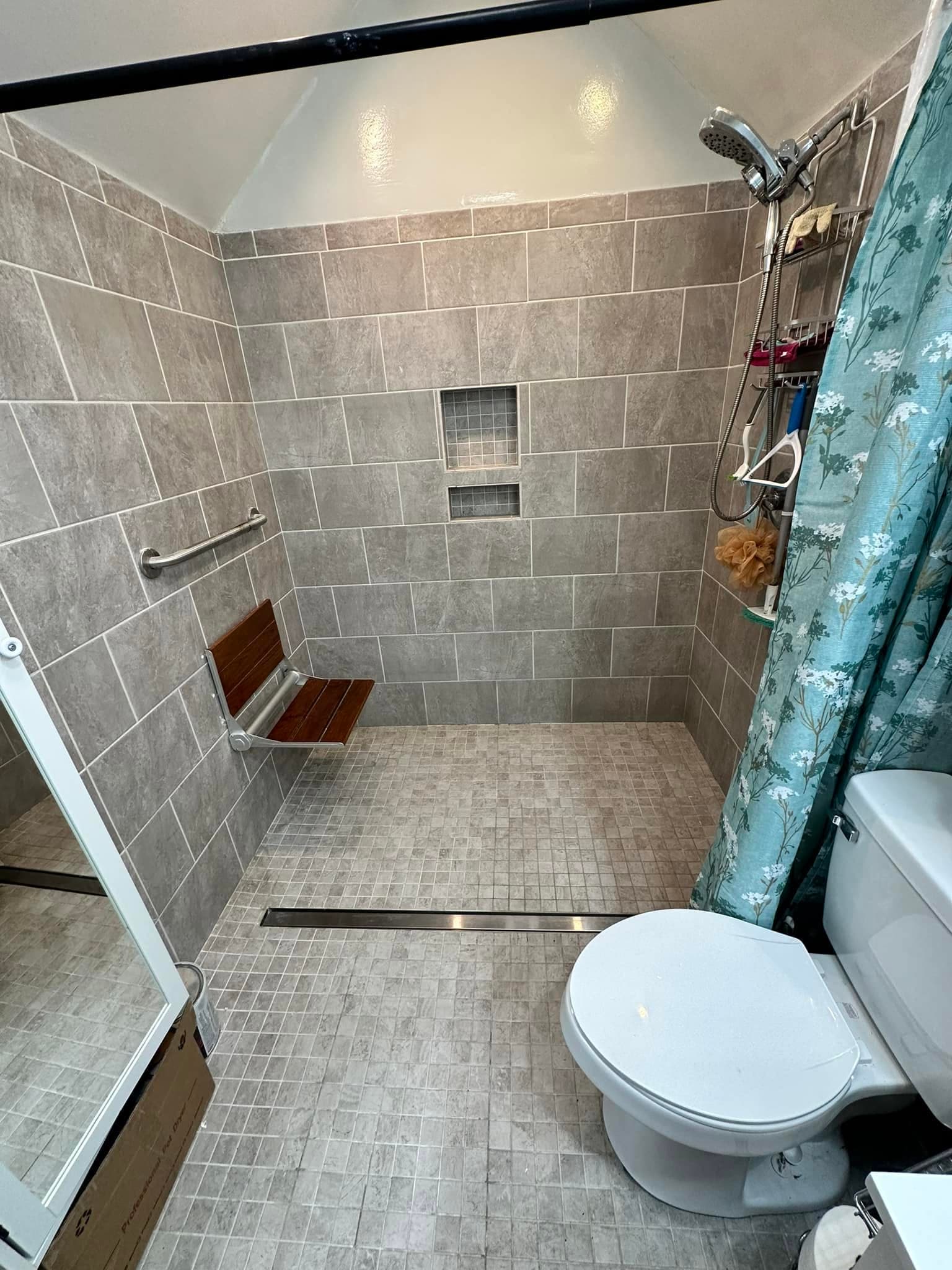 Accessible curbless shower with grab bar installed by Newman's Plumbing near Carrollton, VA