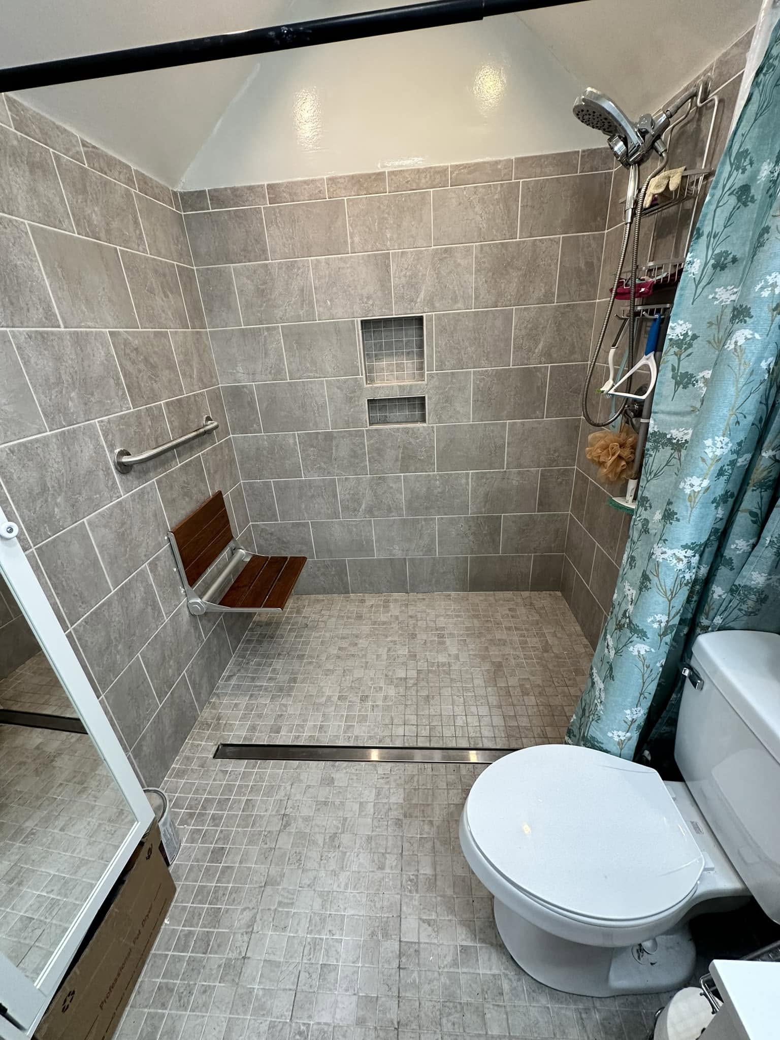 Accessible curbless shower with grab bar installed by Newman's Plumbing near Carrollton, VA