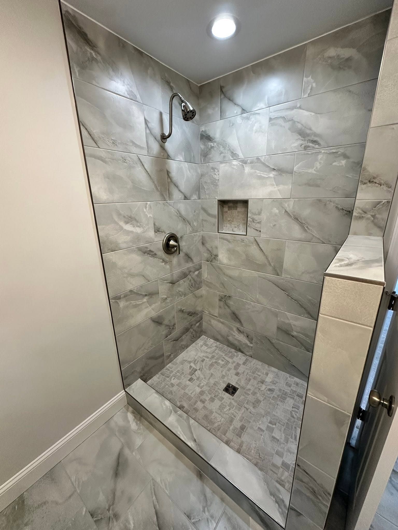 Custom marble walk-in shower remodel completed by Newman's Plumbing in Portsmouth, VA