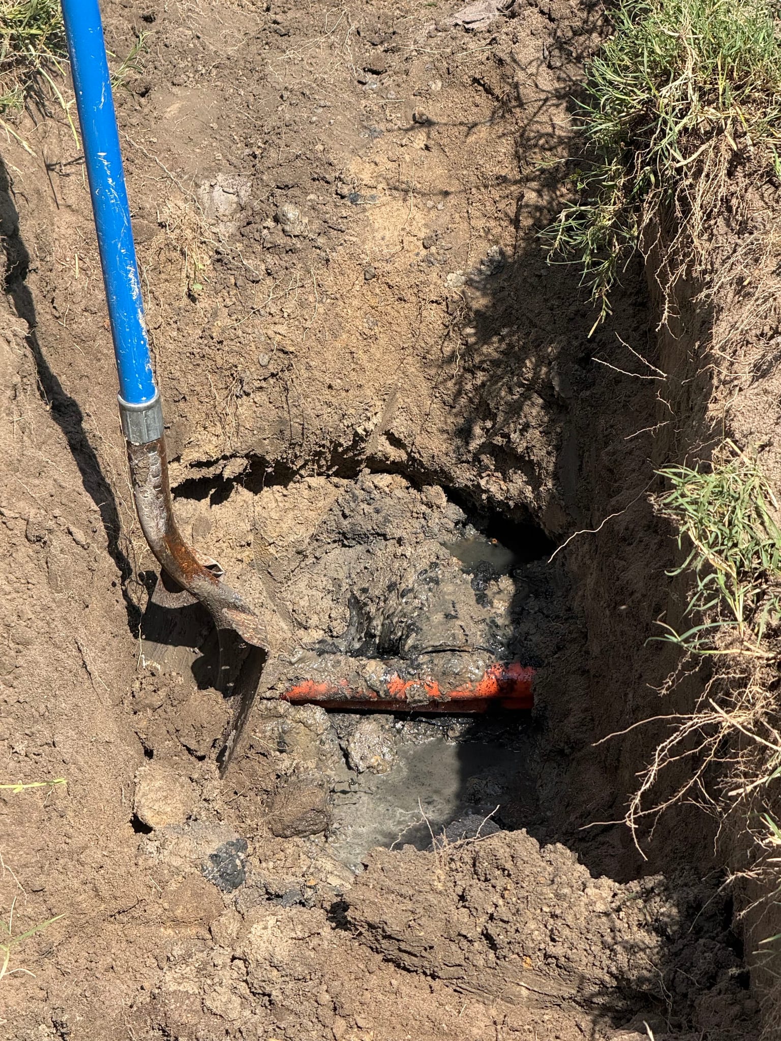 Leaking underground water line uncovered in an excavated trench by Newman's Plumbing in Portsmouth, VA