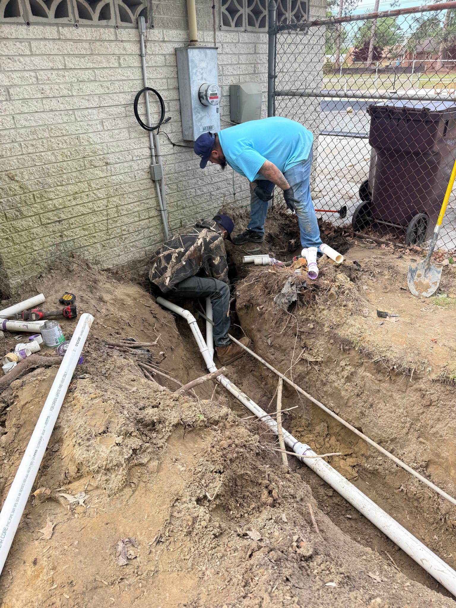 Newman's Plumbing technicians laying new PVC sewer line in an open trench in Portsmouth, VA